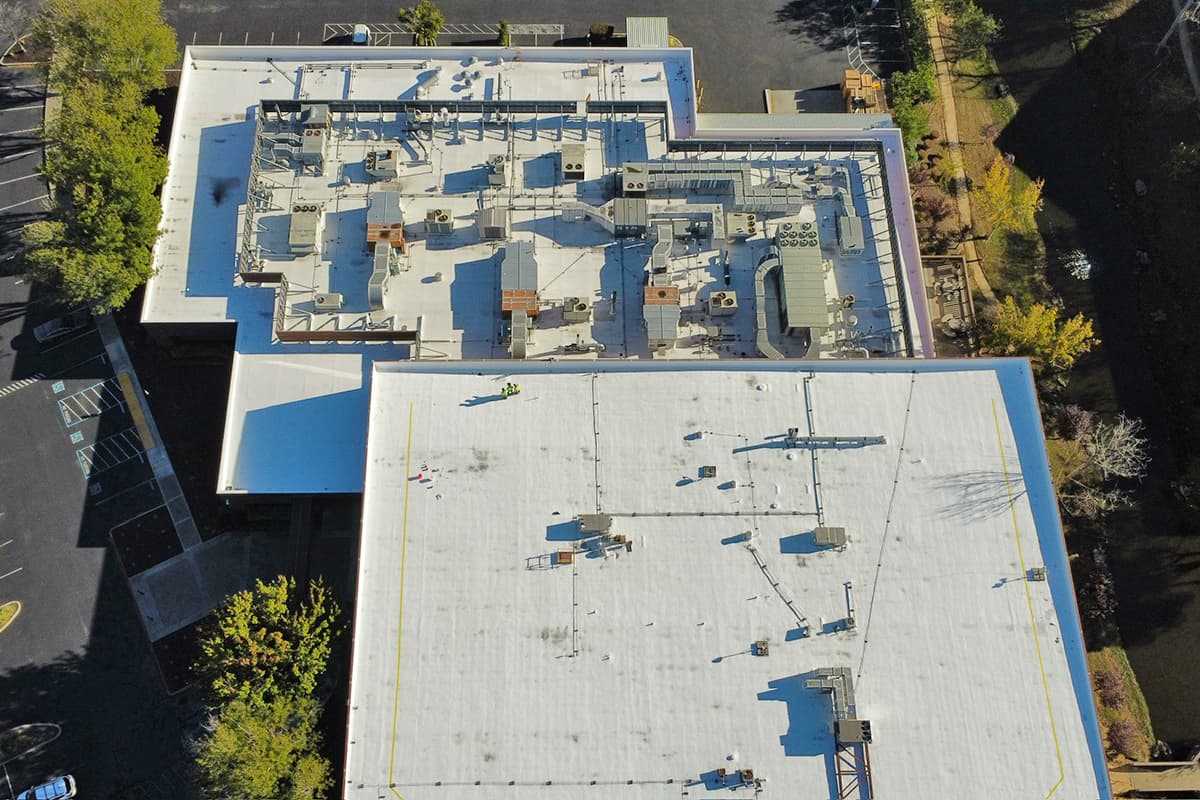 Aerial view of a multi-section commercial roof coating project